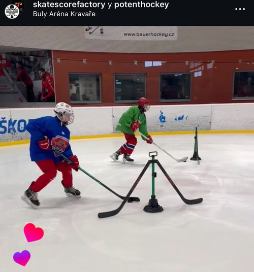 Two players skating through a drill with multiple Spin Defenders on ice