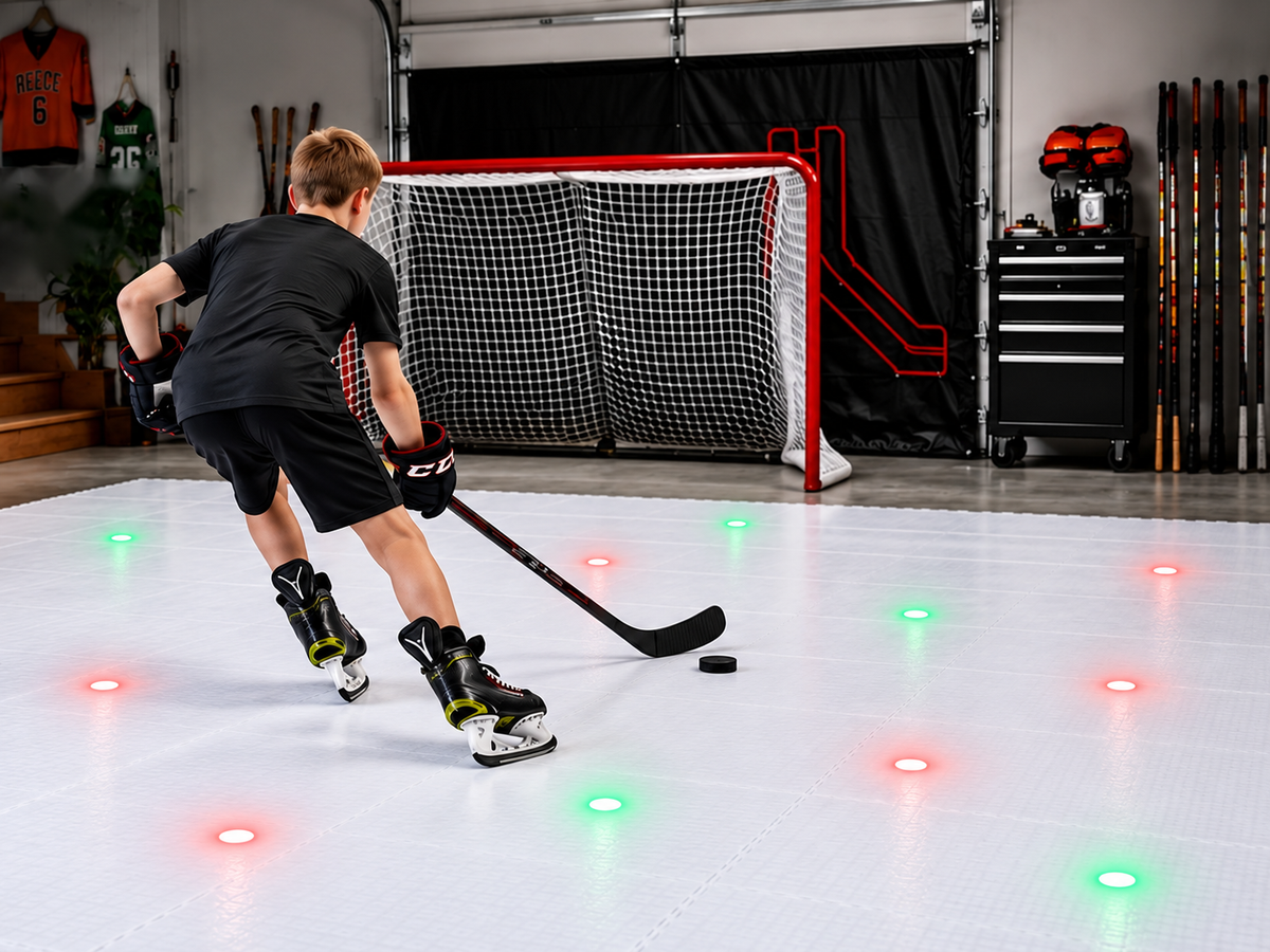 Young player skating with a puck on Potent ice tiles in a home garage